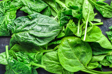 Fototapeta na wymiar spinach green fresh leaves the petals snack vegetables bush green stems and petals Menu concept serving size. food background top view copy space for text keto or paleo diet organic healthy eating