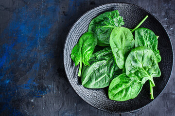 spinach green fresh leaves the petals snack vegetables bush green stems and petals Menu concept serving size. food background top view copy space for text keto or paleo diet organic healthy eating