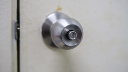 Close up view of metal brass door knob. A handle on a door that is turned to release the latch. Selective focus.