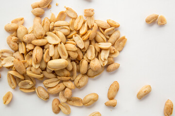 A pile of peanuts separated on a white background