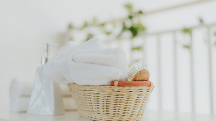 Fototapeta na wymiar White towel with basket in bathroom