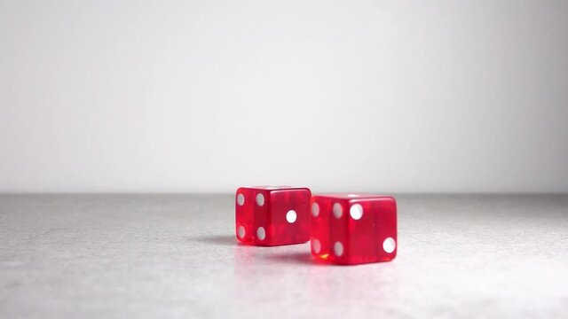 Red dice rolling in slow motion. Random number. Concept of gambling, chance and success.