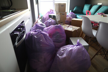 Kitchen is full garbage bags and cardboard boxes