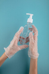 Fototapeta premium Hands in rubber gloves using wash hand sanitizer antiseptic gel pump dispenser for protection coronavirus, germ and bacteria, health care concept,
