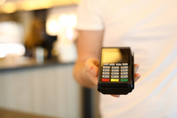 Man holds commercial portable banking terminal