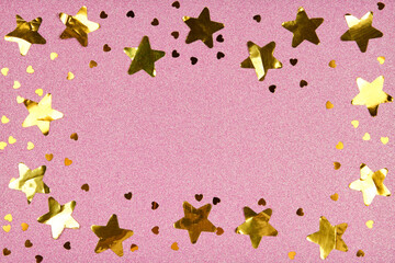 Frame with golden confetti stars and hearts on glittery pink background. Birthday, Christmas, holiday, wedding, celebration, New Years Eve, Festive concept. Copyspace. Greeting card or invitation. .