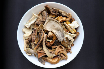 dried forest mushrooms on a white dish