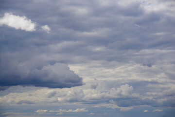 Photo of fluffy blue clouds, the sky before a thunderstorm.