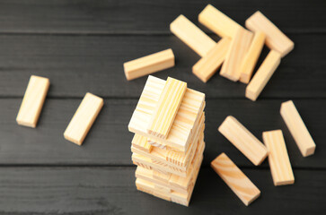 Wooden blocks disrupted on black background. Top view