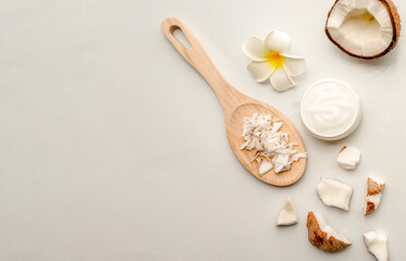 Homemade coconut products on white wooden table background. Oil, scrub, milk, lotion, mint and himalayan salt from top view. Good for space and background
