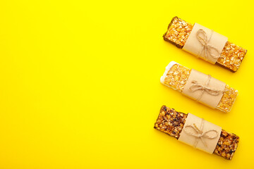 Energy bars - snack for healthy still life with copy space on yellow background.