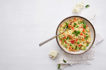 Cauliflower rice in bowl on a white background. Paleo Food Diet Concept