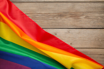 Rainbow LGBT flag on grey wooden background with copy space