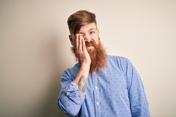 Handsome Irish redhead business man with beard standing over isolated background thinking looking tired and bored with depression problems with crossed arms.