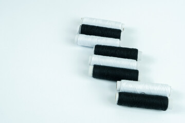 Spools of thread in black and white on a white background, handmade embroidery