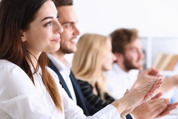 A group of people at the seminar applauded the lecturer in the palm of their hand