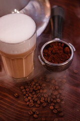 evening cappuccino glass and hookah smoke on wooden background
