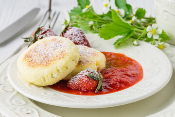 pancakes from cottage cheese with berries, powdered sugar and fresh mint, white wooden background, breakfast