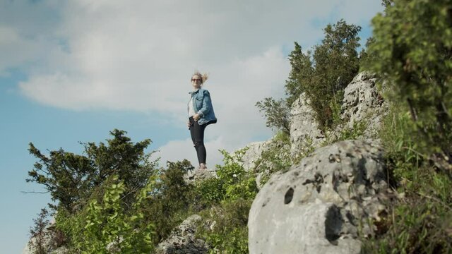Woman Standing on a Top of a Hill