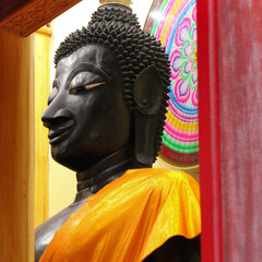 Black colored buddha image of a temple site in Siamese Lao PDR, Southeast Asia