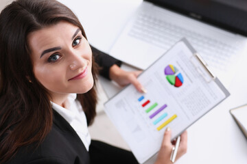 Beautiful smiling cheerful girl at workplace look in camera