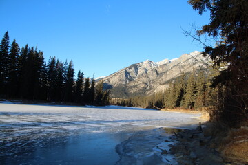 Fototapeta na wymiar Looking Down The Frozen Bow River, Banff National Park, Alberta
