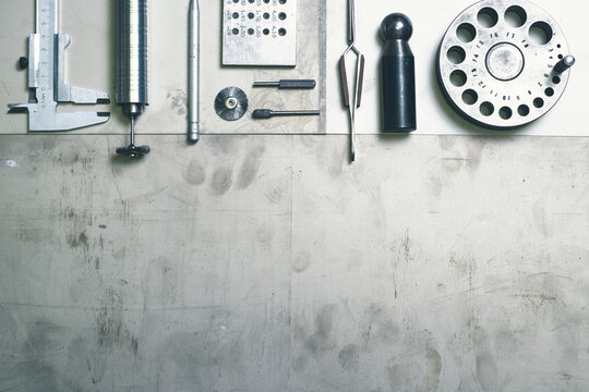 Jewelry tools. Jewellery. Goldsmith workplace, workspace on light background. Hand craft. Workshop. Manufacturing. Closeup. Toned metal top view background