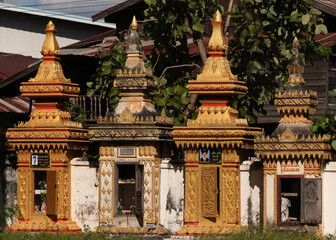 Examples of monks graves in stupa design situated at along the temple wall in Siamese Lao PDR, Southeast Asia