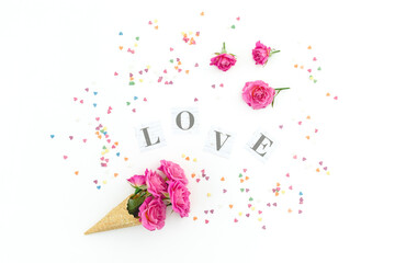 Floral composition with pink roses flowers on white background. Flat lay