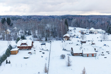 Aerial view on snowy countryside with village houses. Estonia.