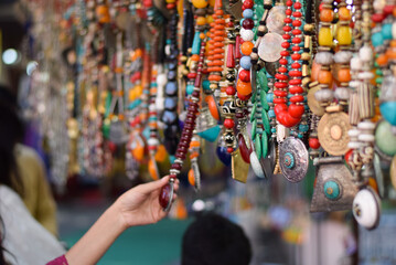 Girl Buying Indian Traditional Handmade Jewellery in Delhi Haat INA Market. This market is famous...
