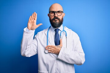 Handsome bald doctor man with beard wearing glasses and stethoscope over blue background Swearing...