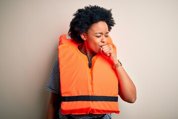 Fototapeta na wymiar Young African American afro woman with curly hair wearing orange protection lifejacket feeling unwell and coughing as symptom for cold or bronchitis. Health care concept.