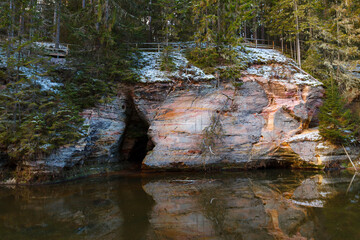 Sandstone cliffs exposed along the river. Winter season. Estonia.