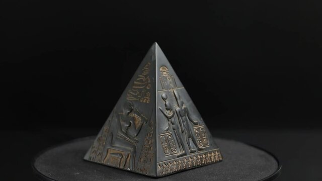 figurine pyramid. pyramid on a black background.
