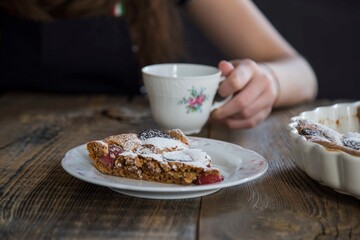 girl drinking cup of tea with brownie. food concept .