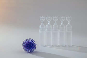 Abstract model of a virus infection and medicine on a grey background.