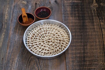 traditional tray ravioli with pepper on wooden background. 