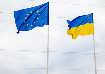 The flag of the European Union and Ukraine fluttering on the flagpole. Flags of Europe.