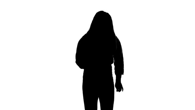 Medium long shot of young sensual beautiful woman dancer with long hair dancing dancehall, hip hop, street modern dance. Slow motion. Contemporary choreography. Black silhouette on a white background
