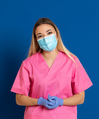 Young doctor wearing a mask face and a pink uniform