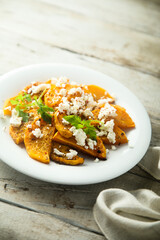 Roasted pumpkin with spices and fresh cheese