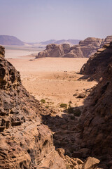 Desert with mountains with tents in the background