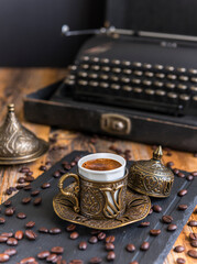 Turkish coffee in traditional copper cup on wooden background. .