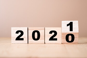 Hand flipping wooden blocks for change year  2020 to 2021 . New year and holiday concept.
