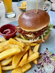 Close up of big tasty burger, french fries and beer