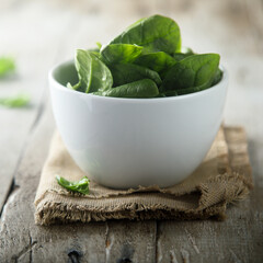 Fresh spinach in a white bowl