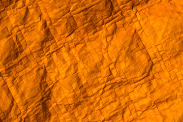 orange wrinkled foil bag. texture or background