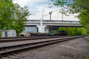 Obraz premium RU, Moscow 26.05.2020: Railroad with several wagons under the flyover