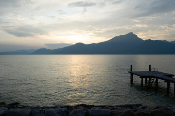 sunset on the lake with wooden jetty